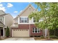 Charming two-story home featuring a brick and siding facade with a two-car garage at 1008 Garden Square Ln, Morrisville, NC 27560