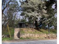 Charming home with lovely trees and a stone retaining wall at 109 Stephens St, Chapel Hill, NC 27516