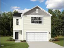 Charming two-story home with a white garage door, light yellow siding and a black front door at 1173 Solace Way, Rolesville, NC 27571