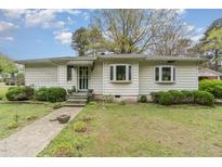 Charming single-story home features a welcoming front yard with mature landscaping and covered entryway at 201 E End Ave, Durham, NC 27703