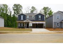 New two-story home featuring a gray exterior, two car garage and a well-manicured lawn at 2202 Cherry Creek Rd, Haw River, NC 27258