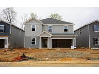 New construction home with gray siding, an open garage, and a covered front entry at 2206 Cherry Creek Rd, Haw River, NC 27258