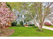Charming two-story home with well-manicured lawn and flowering trees at 2208 Walden Creek Dr, Apex, NC 27523