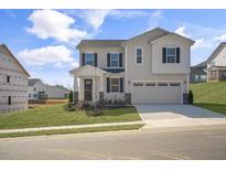 Charming two-story home with a two-car garage, well-maintained lawn, and inviting curb appeal at 279 Providence Creek Dr, Fuquay Varina, NC 27526