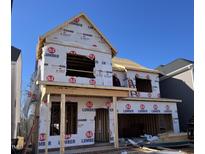 New home being constructed with lumber and blue sky; worker seen on second floor at 304 Catheys Creek Cir, Wendell, NC 27591