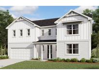 Charming two-story home with a welcoming front porch, attached garage, and manicured lawn at 3300 Clairmeade Dr # 164 Prescott Fh, Fuquay Varina, NC 27526