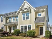 Charming townhome with manicured landscaping, a covered entrance, and a blend of modern and traditional design elements at 912 Ambergate Sta, Apex, NC 27502