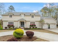 Charming two-story home with gray roof, white trim, and flower boxes under leaded glass windows at 104 Perth Ct, Cary, NC 27511