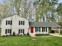 Charming two-story home featuring a red door, black shutters, and a well-manicured lawn at 1100 Medlin Dr, Cary, NC 27511