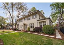 Charming home featuring a well-maintained lawn and lush landscaping at 1403 Wake Forest Rd, Raleigh, NC 27604