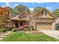 Charming brick and stone home with a well-manicured lawn and inviting curb appeal at 1525 Marshall Farm St, Wake Forest, NC 27587