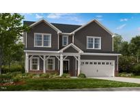 Charming two-story home with a well-manicured lawn and a welcoming front porch at 300 Seagraves Creek Ln, Holly Springs, NC 27540