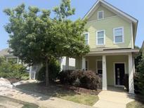 Charming two-story home with light green siding, white trim, and a welcoming front porch at 45 Summersweet Ln, Chapel Hill, NC 27516