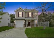 Charming two-story home featuring a well-manicured lawn and an attached single-car garage at 707 Obsidian Way, Durham, NC 27703