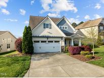 Charming two-story home with manicured lawn, attached two-car garage, and beautiful landscaping at 814 Ember Dr, Durham, NC 27703
