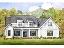 Charming two-story home with inviting front porch, beautiful windows, and a meticulously landscaped yard at 1221 Azalea Garden Cir, Raleigh, NC 27603