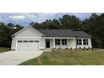 Charming single-story home with a gray exterior, attached garage, and well-manicured front lawn at 170 Eason Creek Way, Clayton, NC 27527
