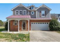 Charming two-story home with a two-car garage and a cozy front porch at 192 Solheim Ln, Raleigh, NC 27603