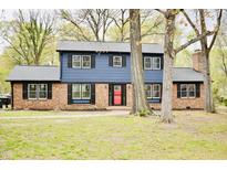 Charming two-story home with brick facade, dark shutters, and a vibrant red front door at 204 N Gurney St, Burlington, NC 27215