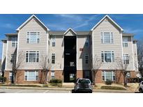 Attractive apartment building featuring light siding, brick accents, and manicured landscaping at 2521 Friedland Pl # 201, Raleigh, NC 27617