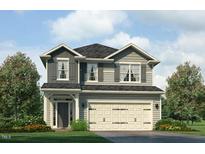 Charming two-story home with a two-car garage, attractive landscaping, and classic architectural details at 384 Hopewell Branch Ct, Smithfield, NC 27577