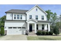 Beautiful two-story home with white siding, attached garage, and manicured lawn at 3908 Bostwyck Dr, Fuquay Varina, NC 27526