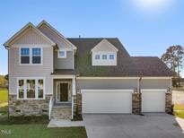 Inviting two-story home featuring a two-car garage and stone-accented facade at 426 Adams Pointe Ct, Angier, NC 27501