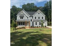 Beautiful new construction featuring modern farmhouse design and professionally landscaped front yard at 70 Valebrook Ct, Youngsville, NC 27596
