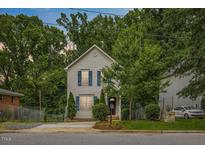 Charming two-story home featuring blue shutters and mature landscaping at 708 Brye St, Durham, NC 27703