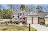 Charming home with well-manicured lawn, two-car garage, and mature trees at 76501 Rice, Chapel Hill, NC 27517
