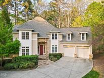 Charming home with a stone entryway, complemented by a manicured lawn and an attached two-car garage at 10370 Spaight, Chapel Hill, NC 27517