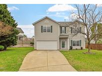 Charming two-story home with a well-maintained lawn, attached garage, and green shutters at 109 Wyeth Meadows Ln, Holly Springs, NC 27540