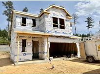 New two-story home showing exterior construction with attached two car garage and building wrap at 180 Muskogee Rd # 53, Angier, NC 27501