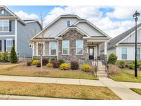 Charming home featuring stone accents, manicured landscaping, and a welcoming front porch at 233 Stone River Dr, Wendell, NC 27591