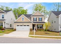 Inviting two-story home boasts a two-car garage, charming exterior, and well-manicured lawn at 270 Trailing Bluff Way, Garner, NC 27529
