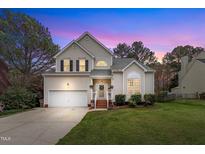 Charming two-story home with mature trees, attached garage, and well-manicured lawn at 2832 Steeple Run Dr, Wake Forest, NC 27587