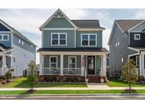 Charming two-story home featuring a welcoming front porch and well-maintained lawn at 304 Rivella Dr, Wake Forest, NC 27587