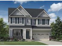 Charming two-story home showcasing a well-manicured lawn, complemented by an attached two-car garage and beautiful architectural details at 333 Parlier Dr, Cary, NC 27519