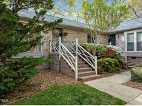Charming brick townhome featuring a decorative white railing leading to the front entrance at 5500 Fortunes Ridge Dr # 72A, Durham, NC 27713