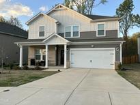 Charming two-story home featuring a covered front porch and a two-car garage at 7105 Stratified Ct, Mebane, NC 27302