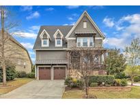 Charming two-story home with a two-car garage and beautifully landscaped front yard at 8121 Greys Landing Way, Raleigh, NC 27615