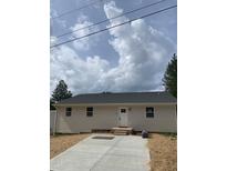 Charming single-story home with a well-manicured lawn, updated roof and inviting front entrance at 905 Ardmore Dr, Durham, NC 27713