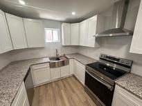 This kitchen features new stainless steel appliances, granite countertops, and white shaker cabinets at 905 Ardmore Dr, Durham, NC 27713