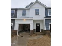 Charming two-story townhome with a brick foundation, an attached garage, and a modern design at 1352 Bessie Ct, Wake Forest, NC 27587