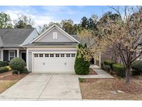 Charming home featuring a two-car garage, well-maintained lawn, and inviting curb appeal at 151 Rosedale Creek Dr, Durham, NC 27703