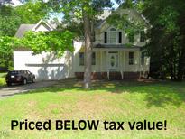 Traditional two-story home with a well-manicured lawn and attached two-car garage at 1623 Rogers Pointe Ln, Creedmoor, NC 27522