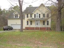 Charming two-story home with a classic design, complemented by a well-manicured front yard and attached garage at 1623 Rogers Pointe Ln, Creedmoor, NC 27522