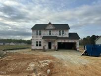 New two-story home under construction features an attached two-car garage and a modern roof design at 163 N Movado Trl, Kenly, NC 27542