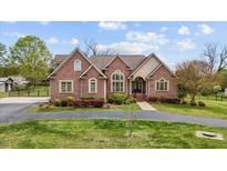 Charming brick home with well-manicured lawn and inviting curb appeal in a quiet neighborhood at 2011 Gibsonville Ossipee Rd, Elon, NC 27244