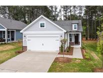Charming home with a two-car garage, craftsman details, beautiful yard, and sidewalk to the front door at 2316 Beeblossom Pl, Fuquay Varina, NC 27526